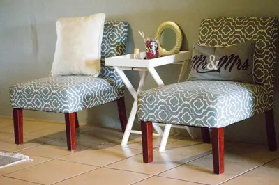 two chairs sitting next to a table and a mirror at Kneizenberg Boutique Lodge & Spa in Louis Trichardt