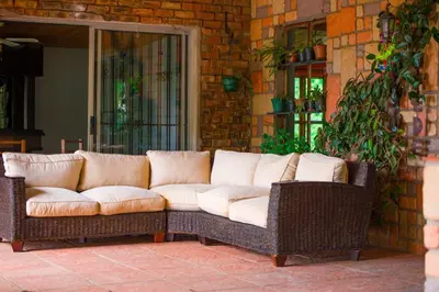 a couch sitting on a patio next to a brick wall at Kneizenberg Boutique Lodge & Spa in Louis Trichardt