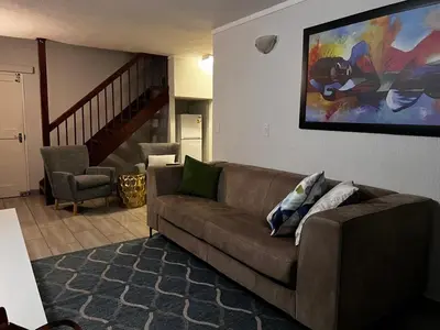 a living room with a couch and a painting on the wall at 50 at Terrace in Nelspruit