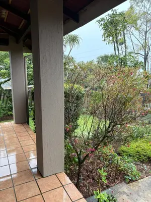 a porch with a view of a garden at The Gem Emerald in Graskop