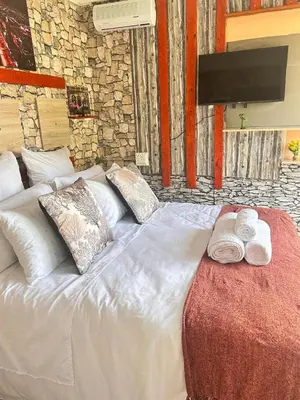 a white bed with two towels on top of it at MRH Self Check- In Express Homestay in Modimolle