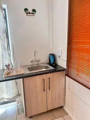 a kitchen counter with a sink and a window at MRH Self Check- In Express Homestay in Modimolle