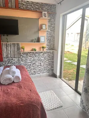 a bedroom with a bed with towels on it at MRH Self Check- In Express Homestay in Modimolle