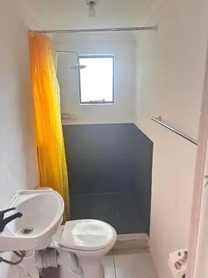 a bathroom with a sink and a toilet and a window at MRH Self Check- In Express Homestay in Modimolle