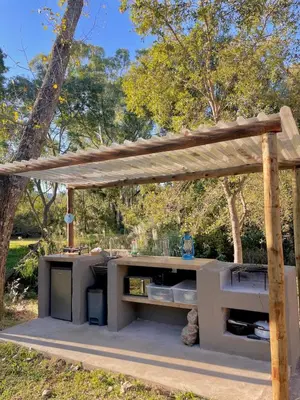 an outdoor kitchen with a wooden pergola at Hot spring tiny home in Limpopo in Gemsbokfontein