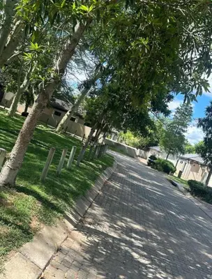 a street with trees on the side of a road at Riverside Gardens 2 bedroom Home in Nelspruit