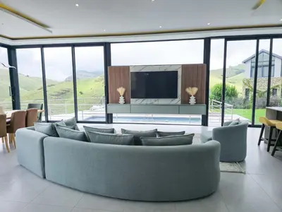 a living room with a couch and a tv at The Curve in Dullstroom