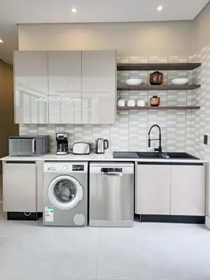a kitchen with a washing machine and a sink at The Curve in Dullstroom