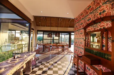 a dining room with a checkered floor at Bush House Zandspruit in Hoedspruit