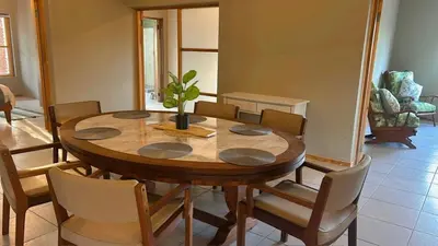 a dining room table with chairs and a plant on it at Maroela 1022 in Marloth Park