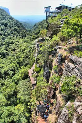 a group of people standing on the side of a mountain at Mogodi Lodge in Graskop