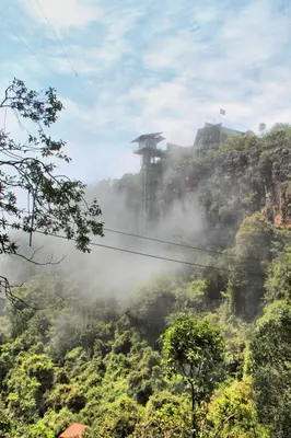 a misty mountain with a building on top of it at Mogodi Lodge in Graskop