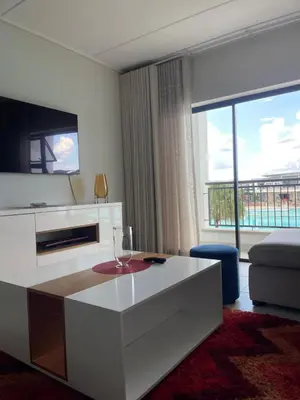 a living room with a white table and a large window at UNIT 1487 The blyde crystal lagoon in Pretoria
