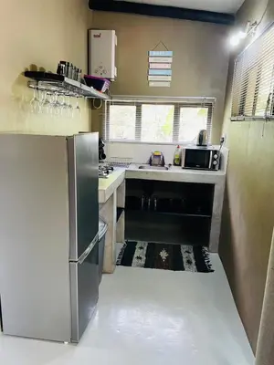 a kitchen with a stainless steel refrigerator and sink at Shiringa kruger lodge in Marloth Park