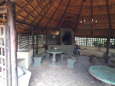 a room with a table and benches in a building at The Golden Eagle Guest House in Kempton Park