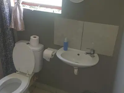 a bathroom with a toilet and a sink at Chalet 4 at Cynthias Country in Hartbeespoort