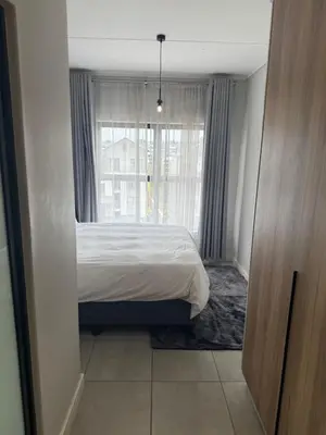 a bedroom with a bed and a window at Treger views in Midrand