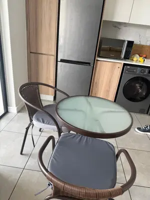 a glass table and two chairs in a kitchen at Treger views in Midrand