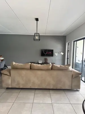 a living room with a brown couch in a room at Treger views in Midrand