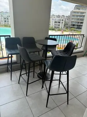a group of chairs and a table on a balcony at Treger views in Midrand