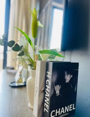 two books sitting on a table next to a plant at SoulSerene Inn in Pretoria