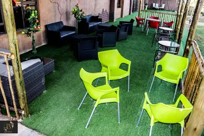 a group of chairs and tables on the grass at Leisure 45 Guest House in Kwaggafontein