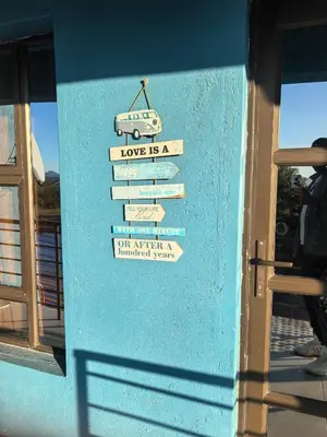 a sign on the side of a blue building at samama guesthouse in Groblersdal
