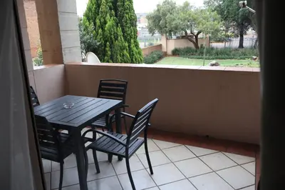 a table and chairs on a balcony with a view at Lovely Home away from Home in Centurion