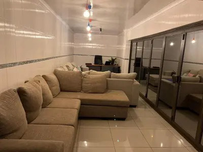 a living room with a couch and a table at Berry Home 4U in Pretoria
