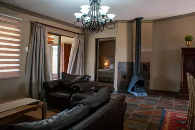a living room with a couch and a fireplace at Casa de la Presa 5 in Polokwane
