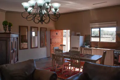 a kitchen and dining room with a table and chairs at Casa de la Presa 5 in Polokwane