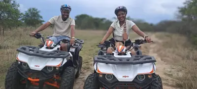 two people riding on atvs on a dirt road at Casa de la Presa 5 in Polokwane