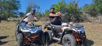 a man and a woman sitting on two atvs at Casa de la Presa 5 in Polokwane