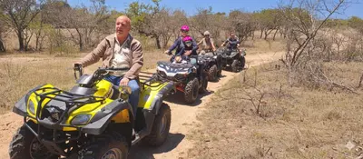 a group of people riding atvs on a dirt road at Casa de la Presa 5 in Polokwane