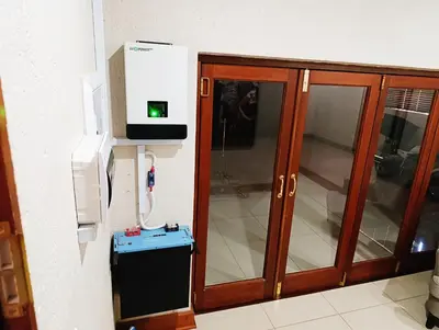 a wooden cabinet with a phone and a thermosphericermottermott at Elephant Villa in Nelspruit