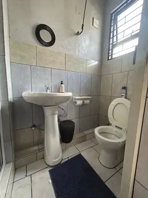 a bathroom with a sink and a toilet at Entire rental unit in Pretoria
