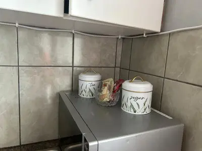 two buckets sitting on top of a shelf in a kitchen at Entire rental unit in Pretoria