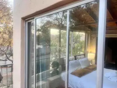 a glass window of a bedroom with a bed at Executive loft at Brooklyn in Pretoria