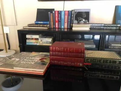 a pile of books sitting on a table at Executive loft at Brooklyn in Pretoria