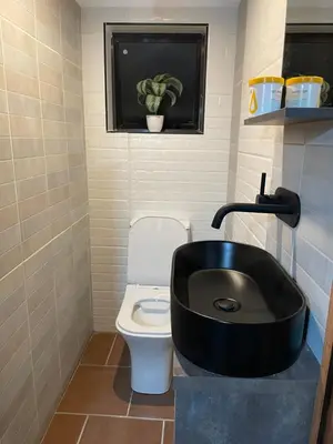 a bathroom with a black sink and a toilet at Executive loft at Brooklyn in Pretoria