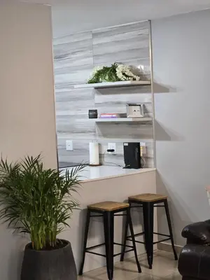 a counter with two stools in a room with a plant at Ikar's Haven in Centurion