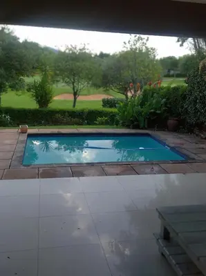 a small swimming pool in a yard with a bench at Dream Retreat Pecanwood Golf Estate in Hartbeespoort