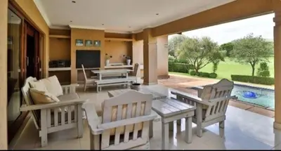 a living room with a table and chairs and a pool at Dream Retreat Pecanwood Golf Estate in Hartbeespoort