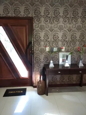 a room with a door and a table with vases at Dream Retreat Pecanwood Golf Estate in Hartbeespoort