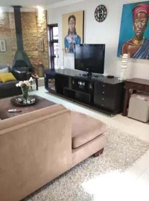 a living room with a couch and a tv at Dream Retreat Pecanwood Golf Estate in Hartbeespoort