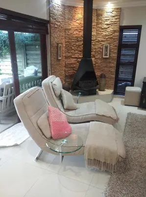 a living room with a couch and a fireplace at Dream Retreat Pecanwood Golf Estate in Hartbeespoort
