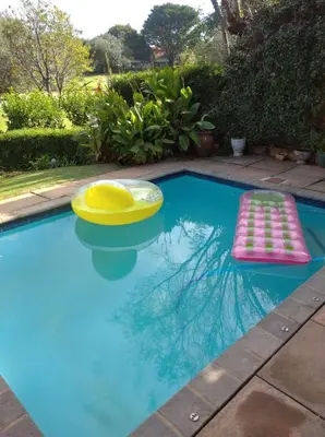 a swimming pool with a frisbee and two mats in it at Dream Retreat Pecanwood Golf Estate in Hartbeespoort