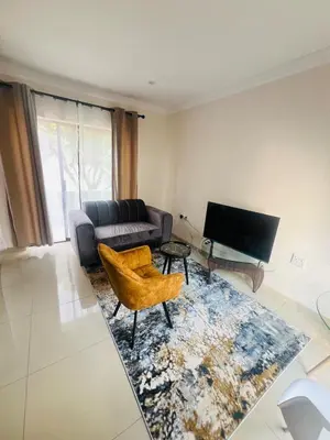 a living room with a couch and a chair at U4 KT View in Midrand