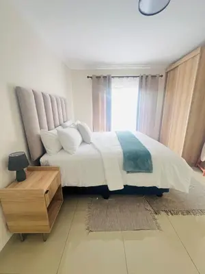 a bedroom with a large white bed with a window at U4 KT View in Midrand
