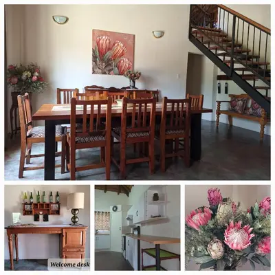 a dining room and kitchen with a table and a staircase at Ouma se Huis in Tierpoort